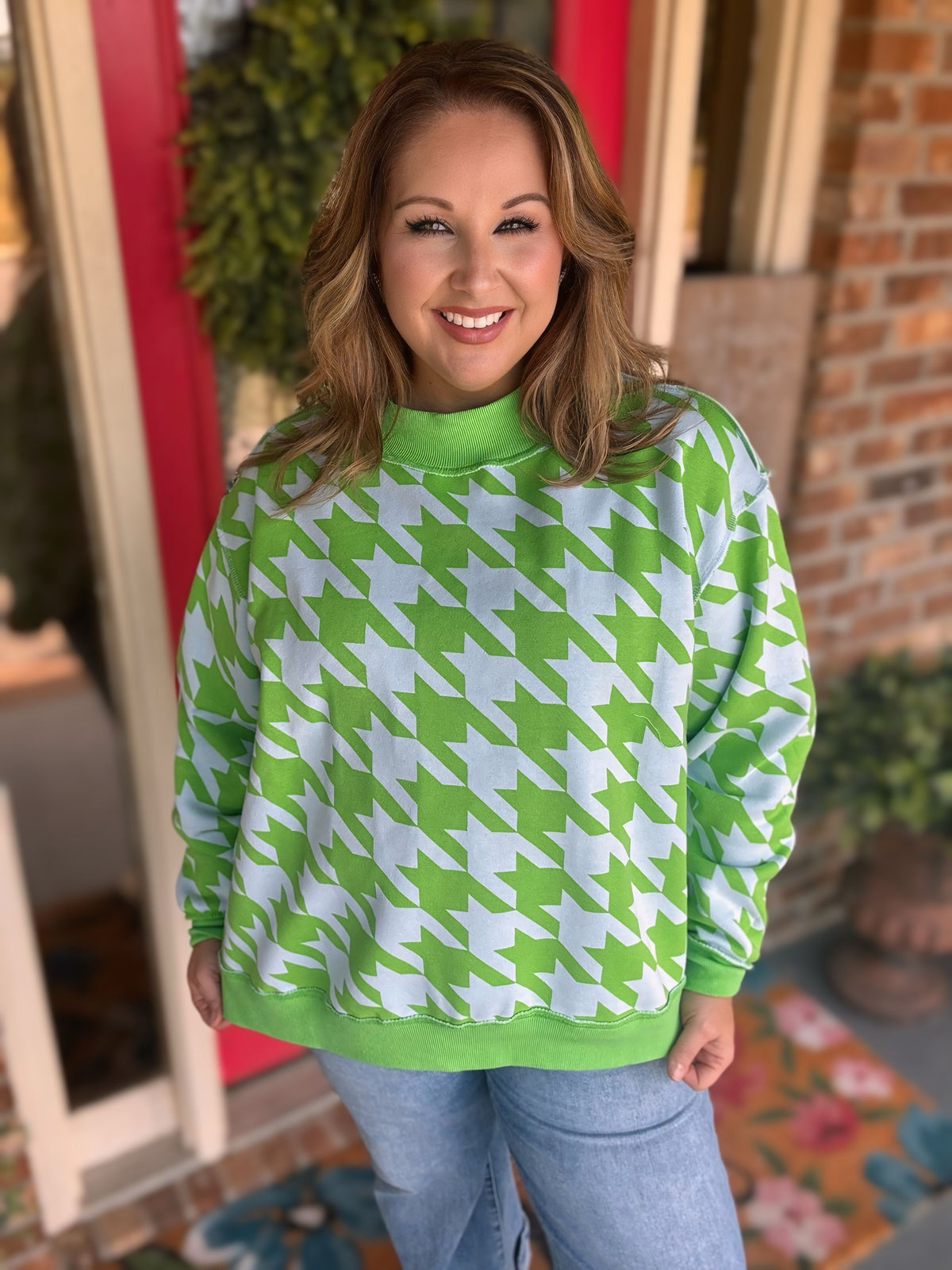 Reversible light blue and green Amen mock neck sweatshirt shown with green lettering on one side and a houndstooth print on the reverse.