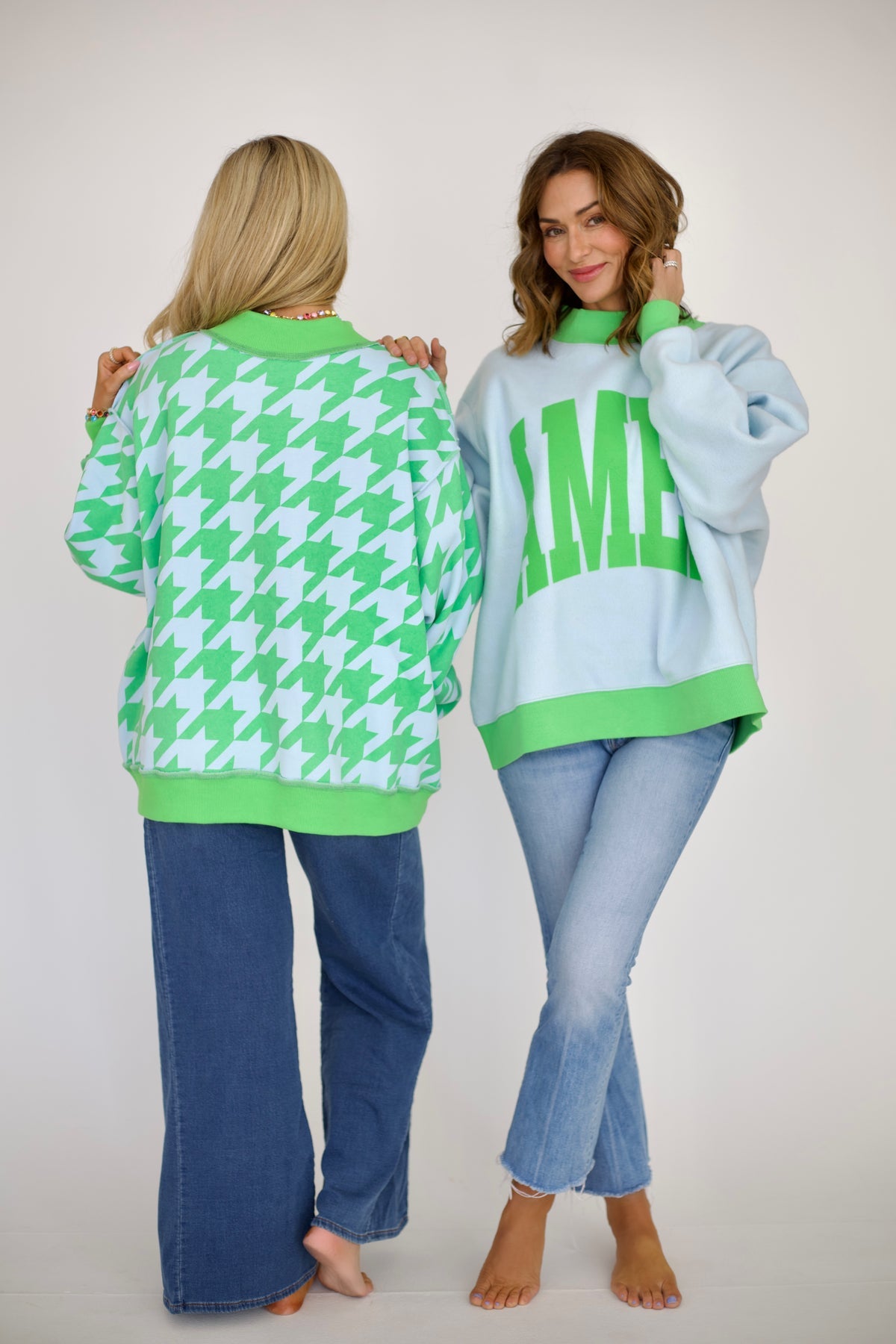 Reversible light blue and green Amen mock neck sweatshirt shown with green lettering on one side and a houndstooth print on the reverse.