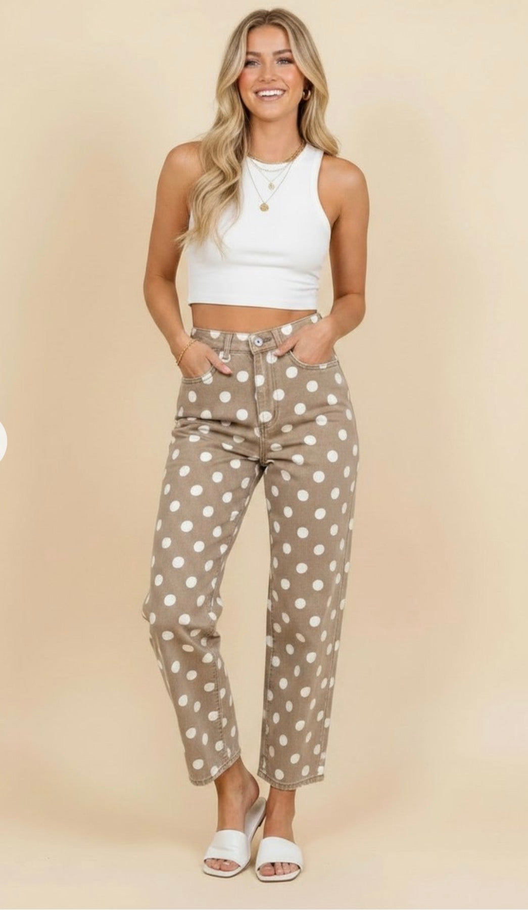 Model wearing taupe pants with white polka dots, a high-rise waist, and cropped straight legs.